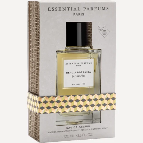 Essential Parfums Néroli Botanica 100 ml - Estuche Estuche gris de Néroli Botanica 100 ml de Essential Parfums en tres cuartos, con ventana troquelada, faja geométrica dorada y lomo de cartón ondulado